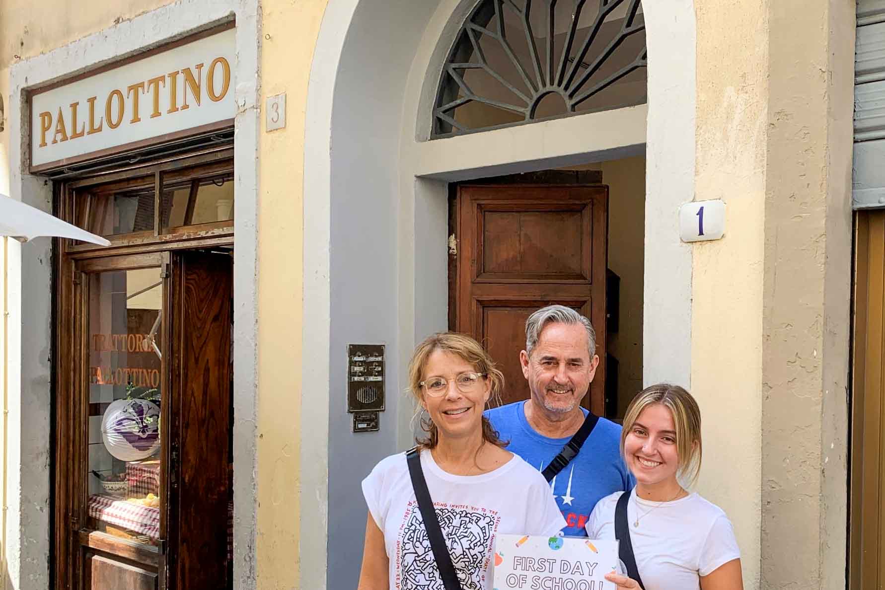 A student poses with her parents on the first day of the semester in Florence.
