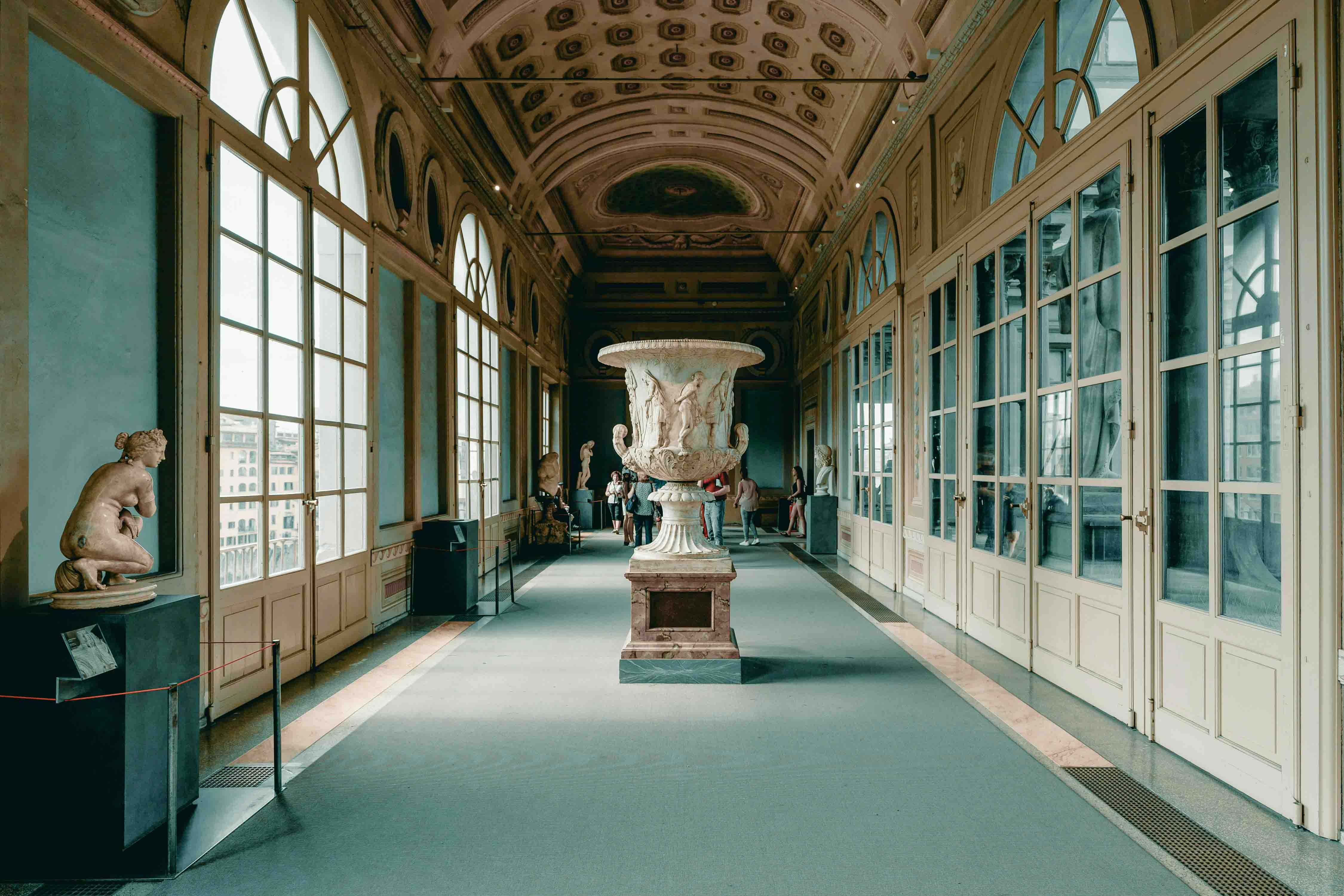 A hall in the Uffizi gallery with statues and other art.