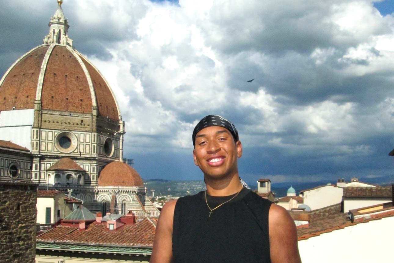 A student in Florence with the Duomo in the background.