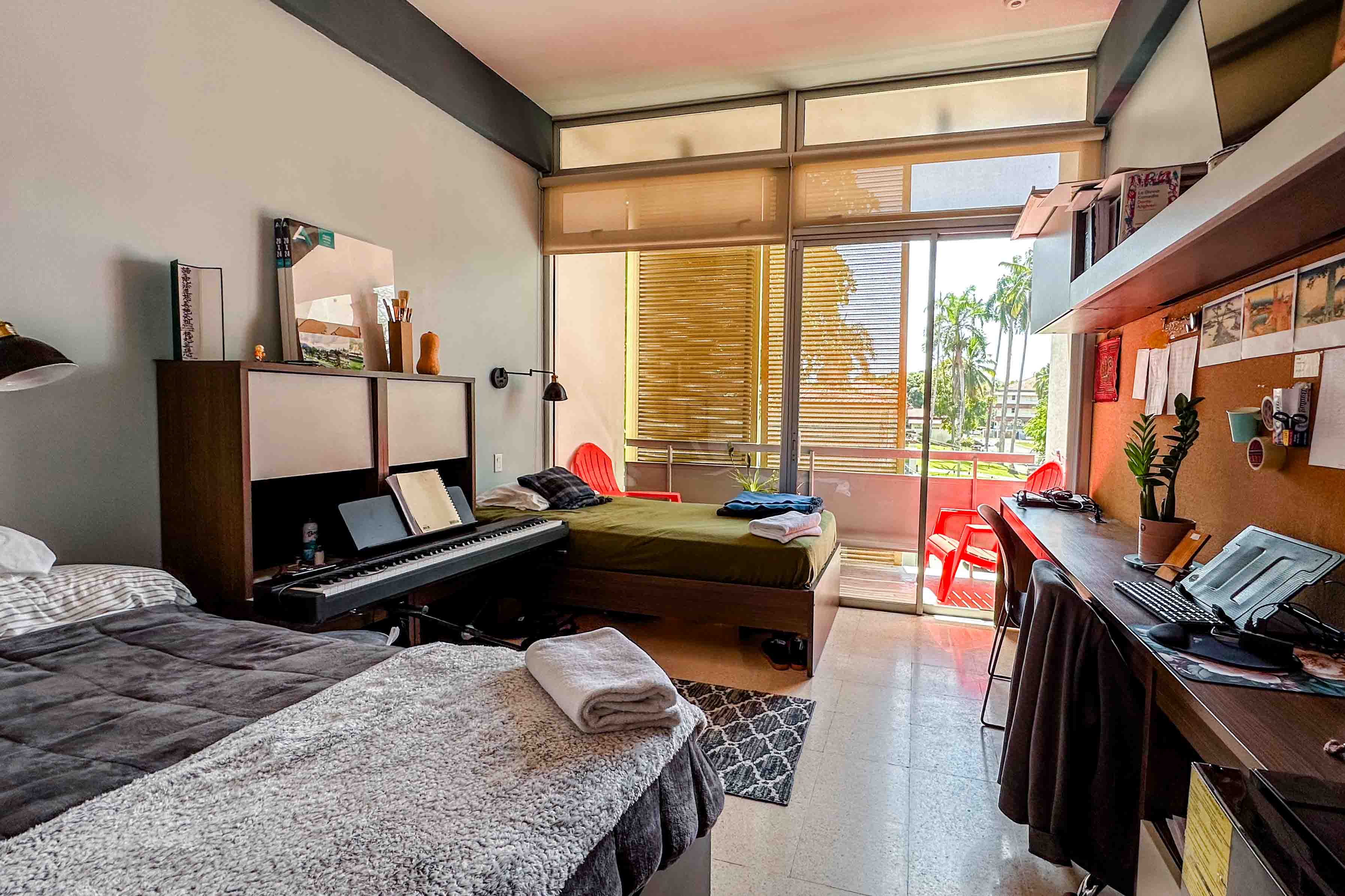 A view of what your FSU Panama dorm room would look like with two beds, desks, and a balcony.