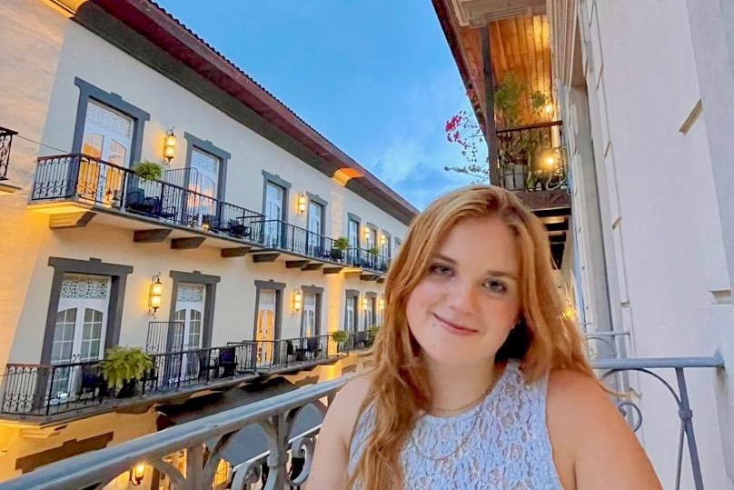A student on a balcony in Casco Viejo, Panama.