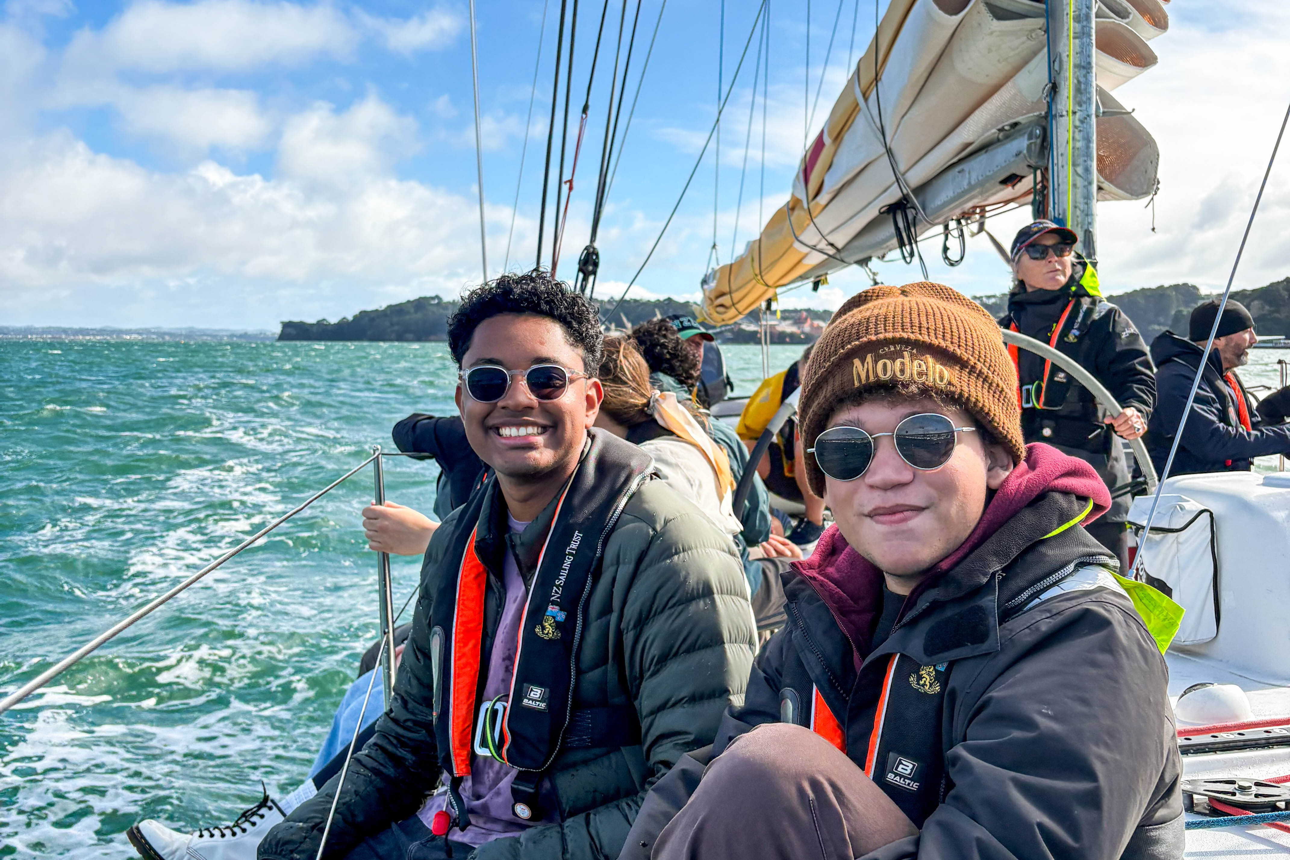 Students posing on a sailboat.