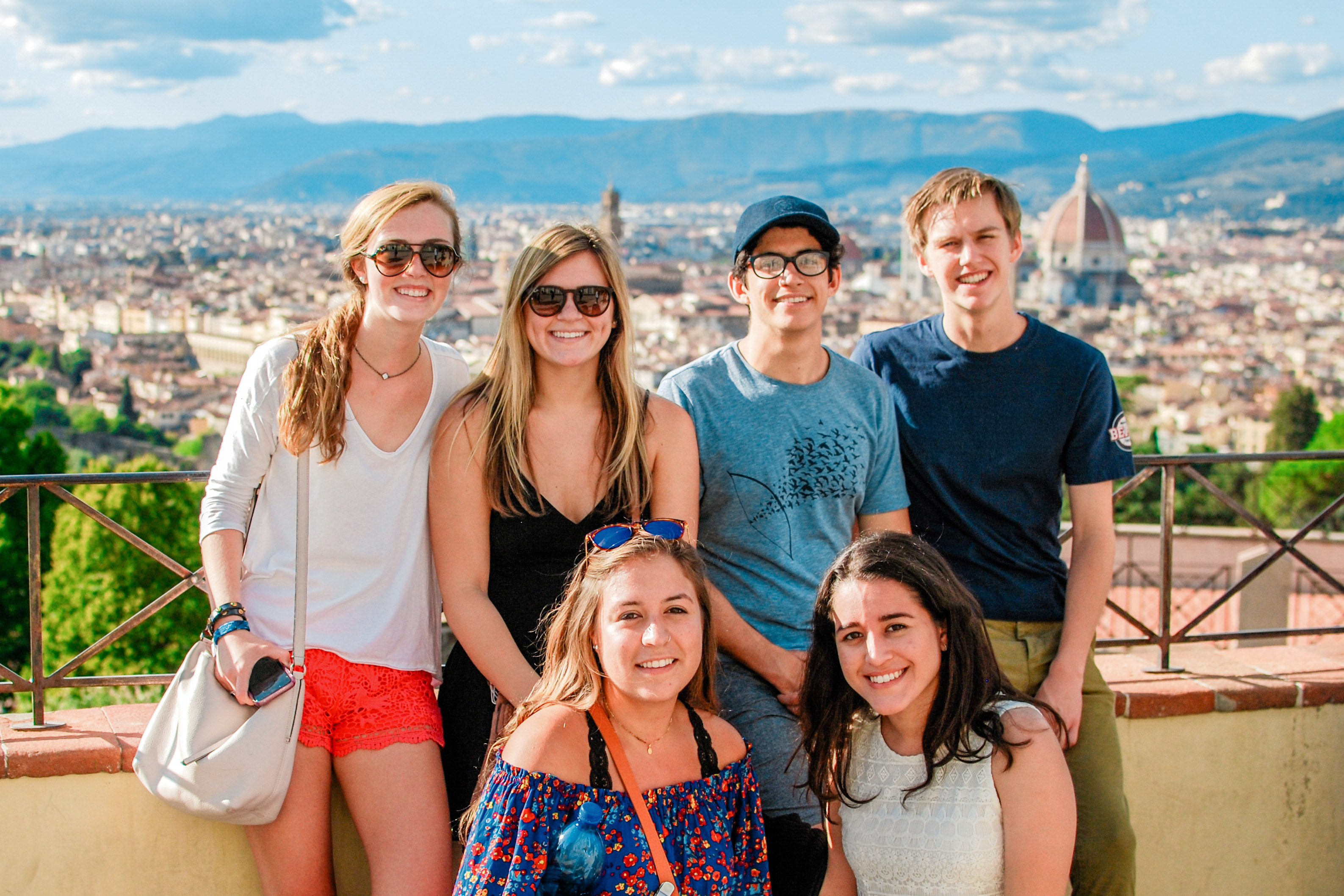 Students posing together with the Duomo in the distance in the background.