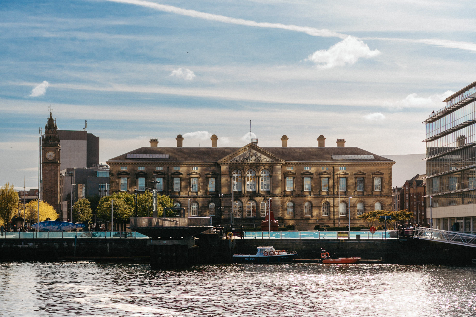 A view of a river and building across the way in Belfast.