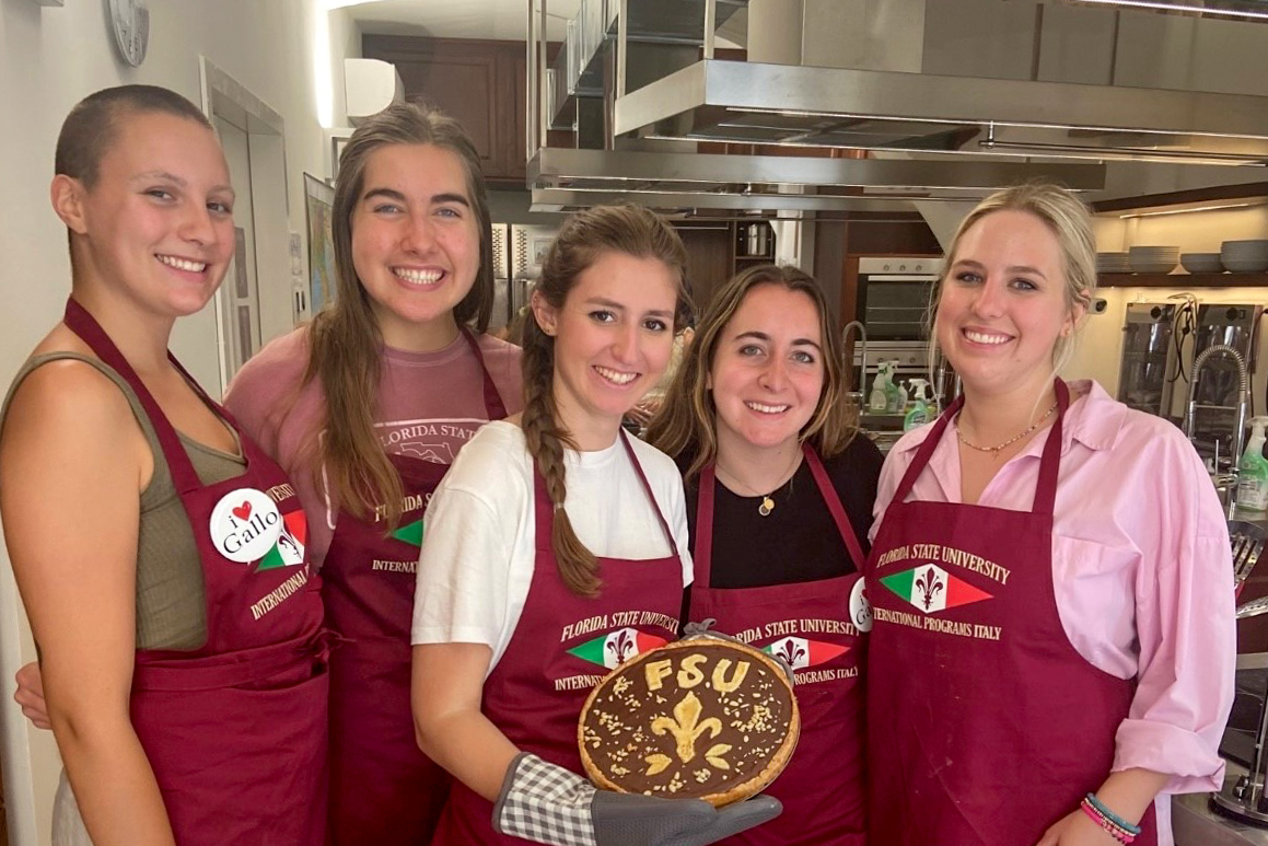 Students posing with food they made in Florence.