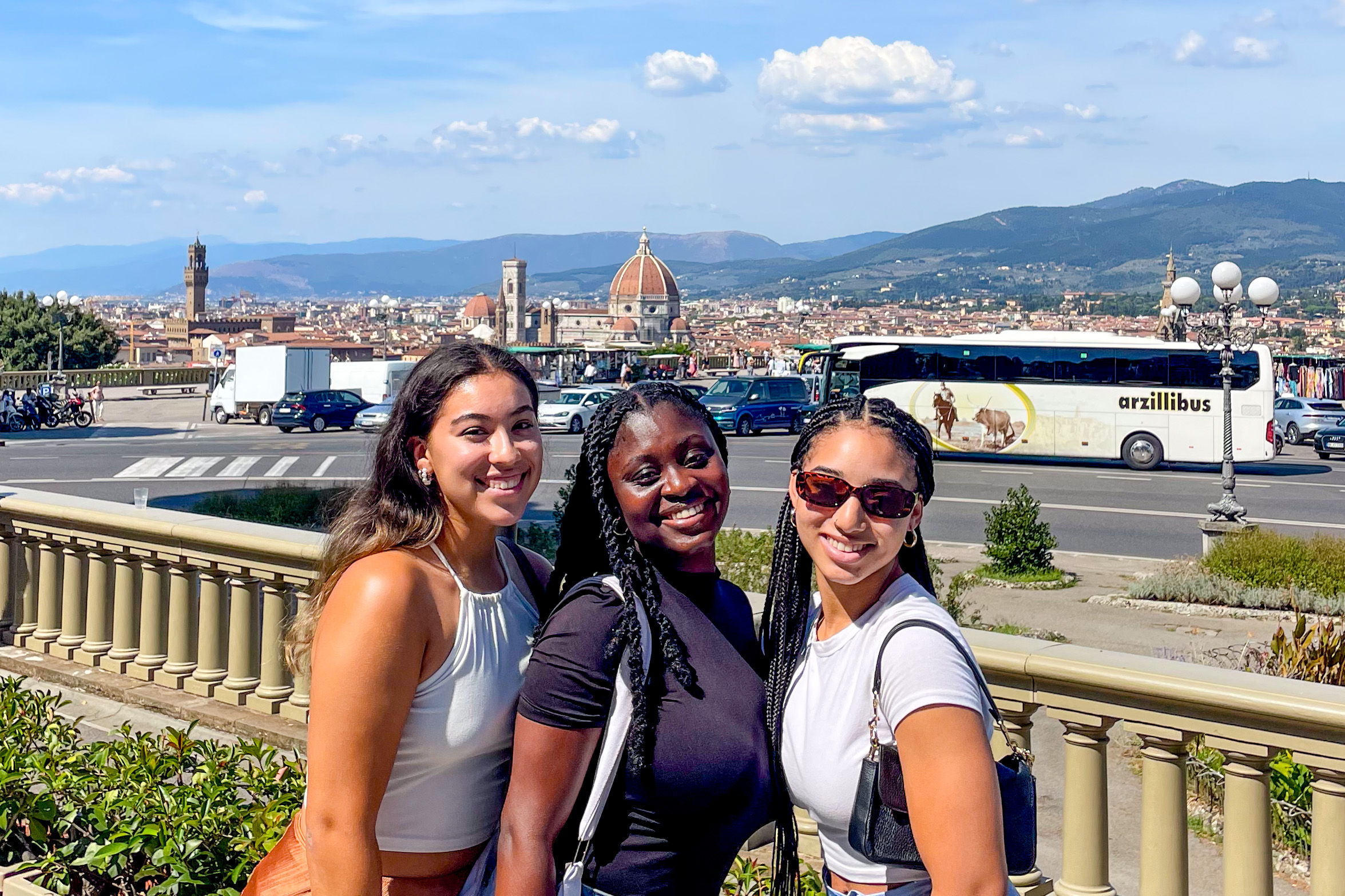 Students posing together in Florence with the Duomo in the distance.