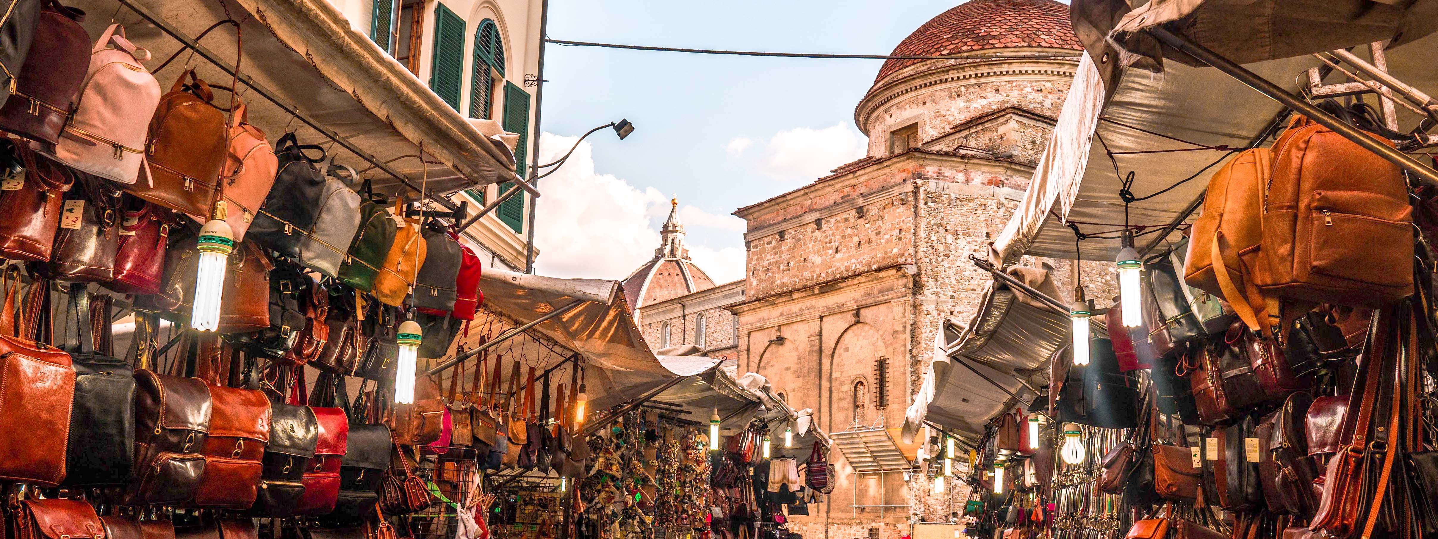 A view of a leather market in Florence with the Duomo in the distance.