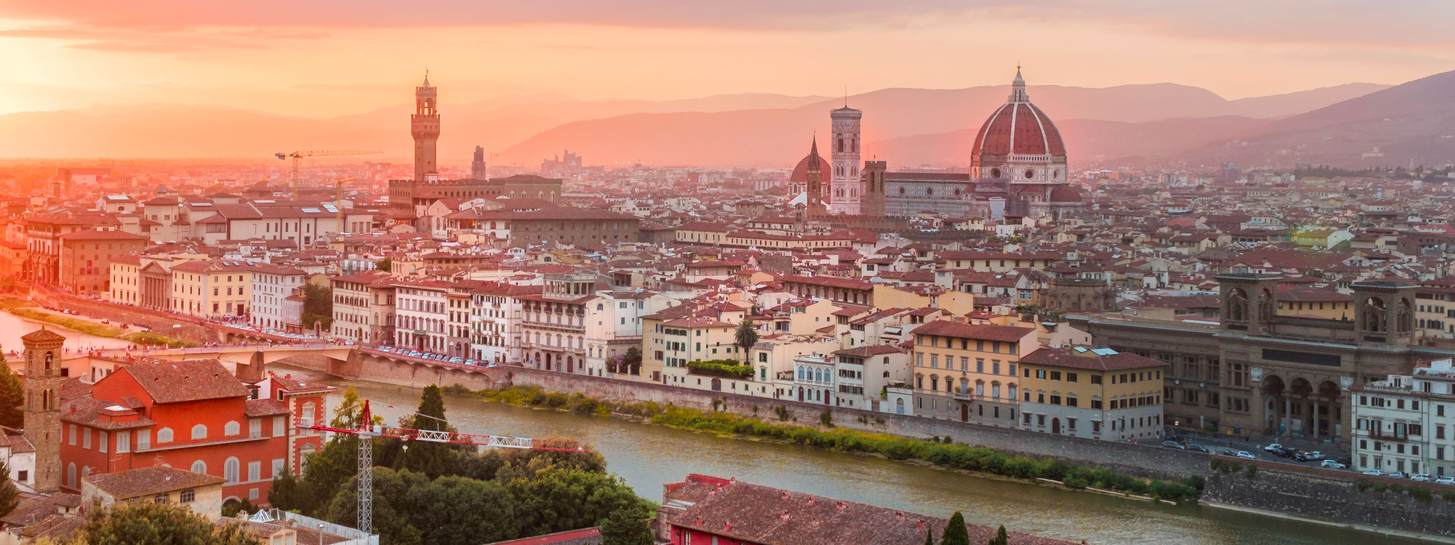 A view of the Duomo and Arno river at sunset.