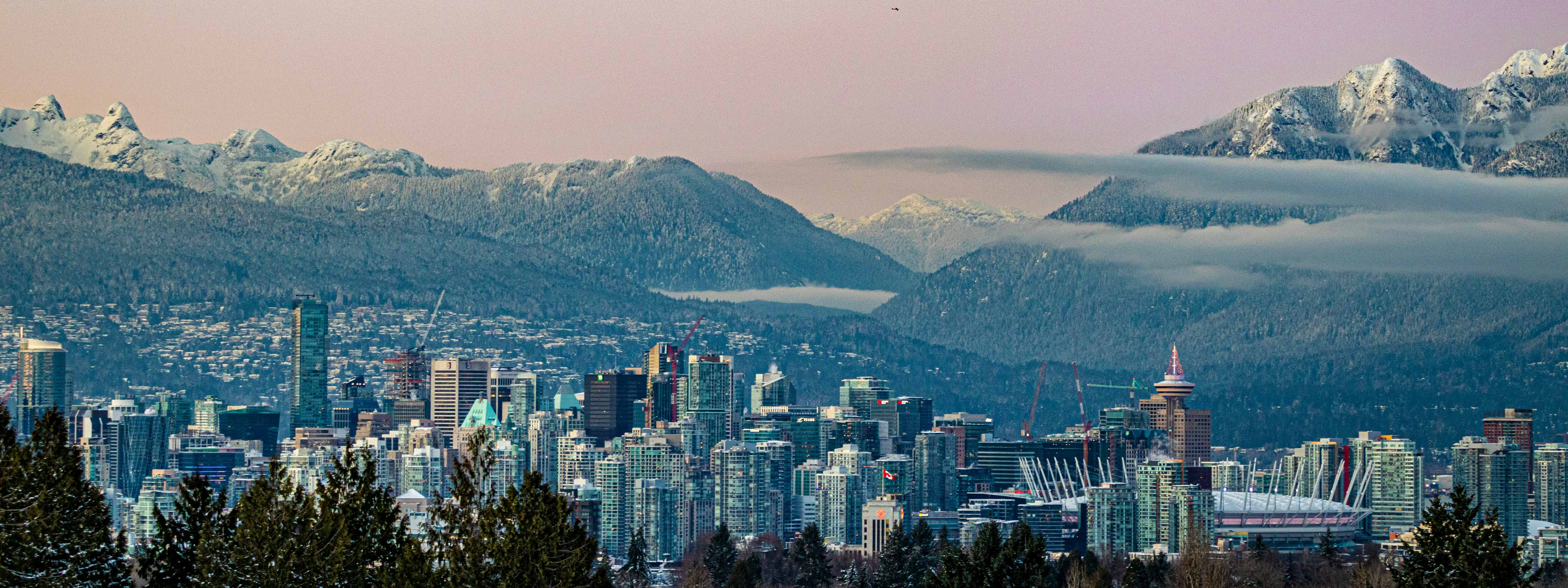 A view of Vancouver with mountains behind.