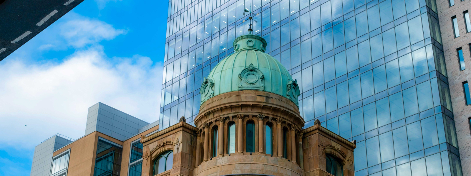 A view of a historic building in Belfast in front of a modern one.