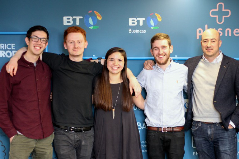 Students posing together at a work function in London.