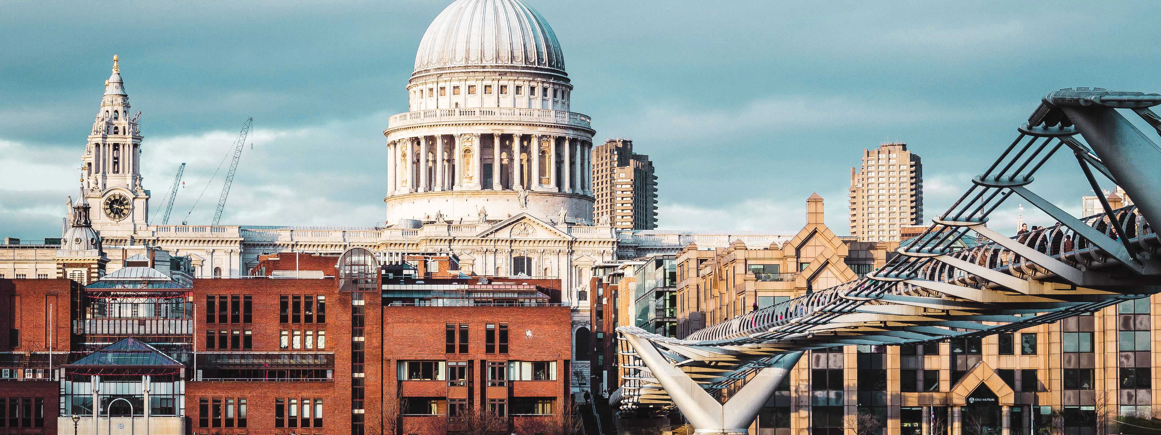 A view of St. Pauls Cathedral in London with the Millennium Bridge in the foreground.