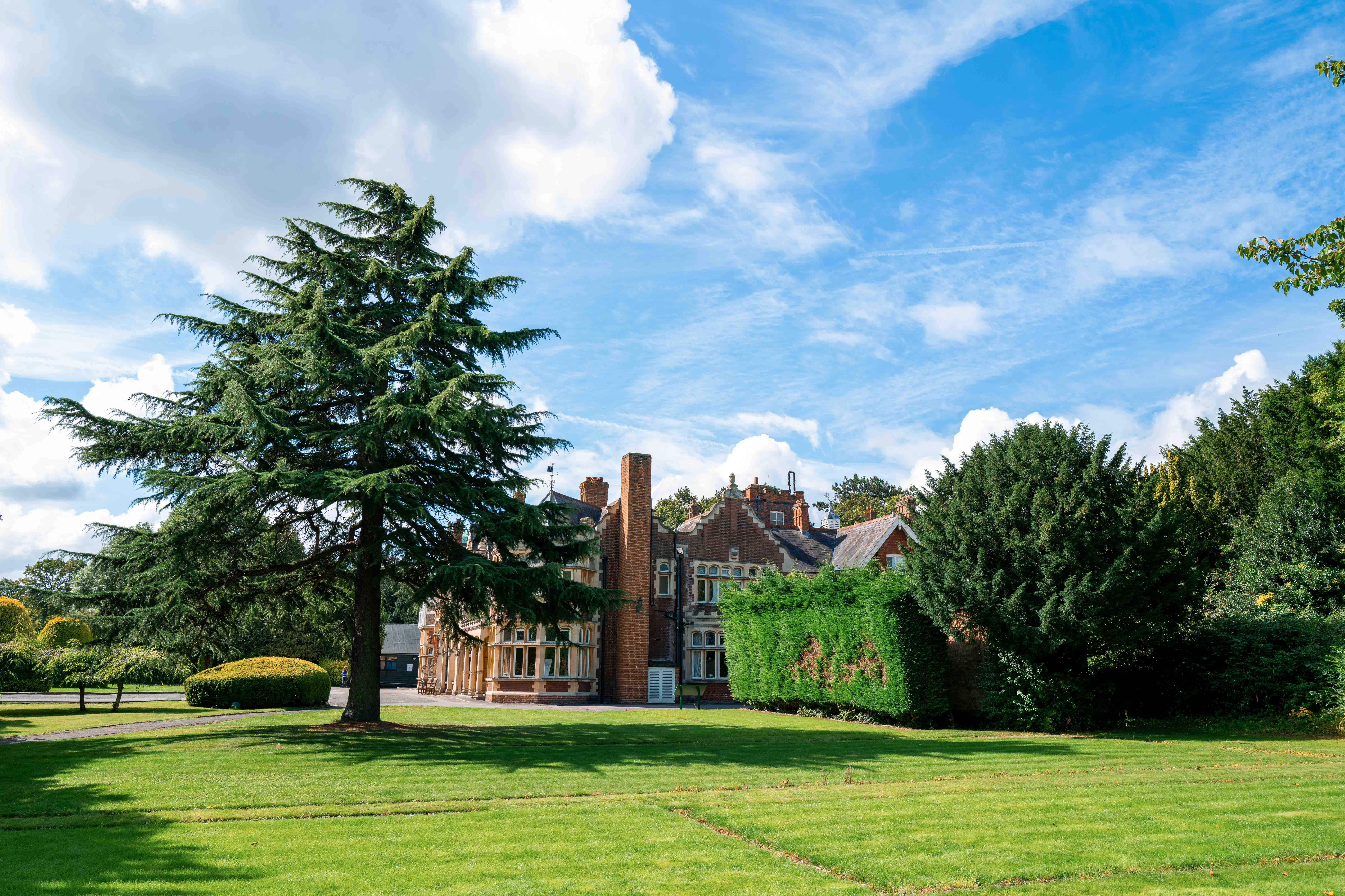 A view of a lawn and house at Bletchley Park.