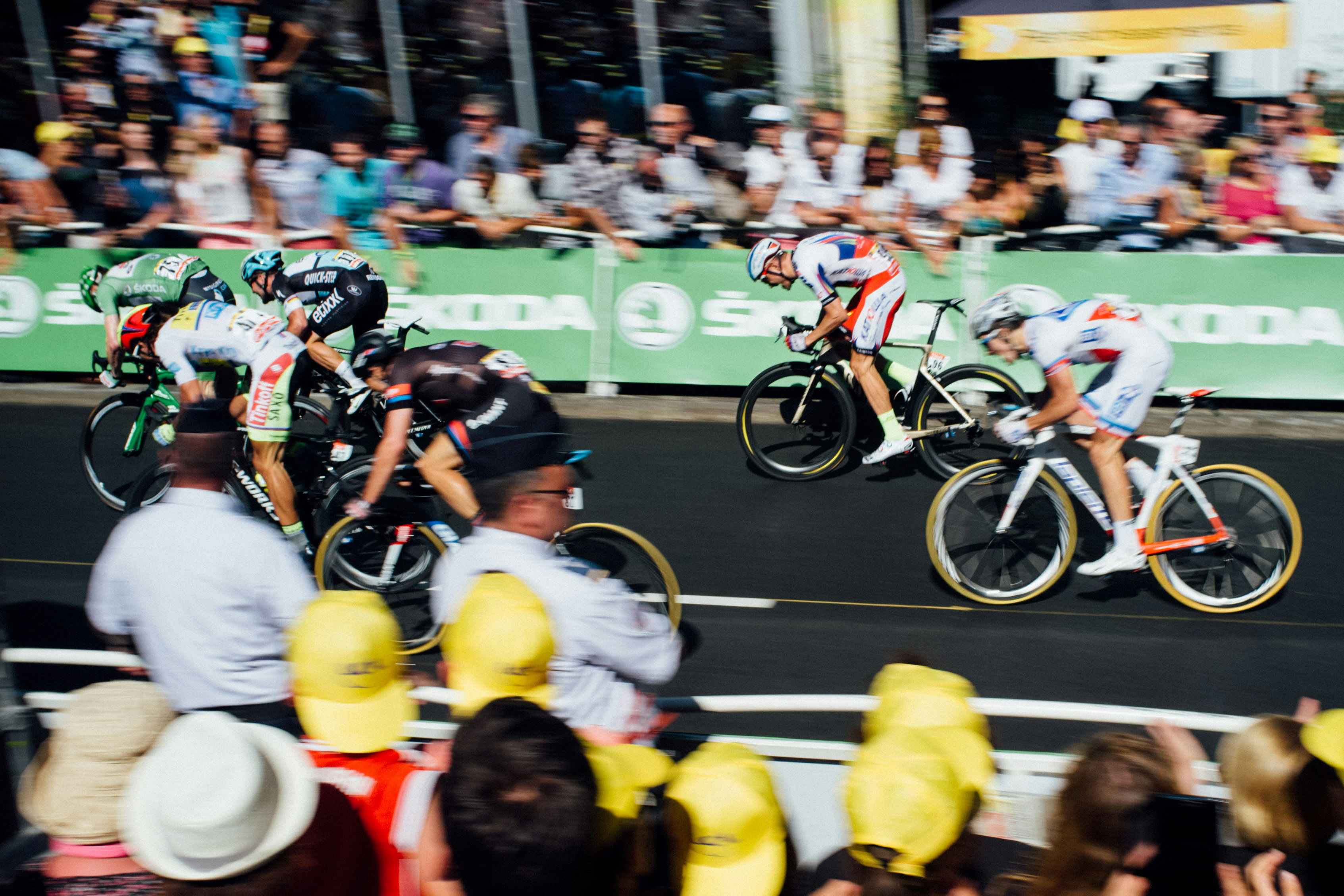 Cyclists speed past the camera in the Tour de France in a blur of athleticism