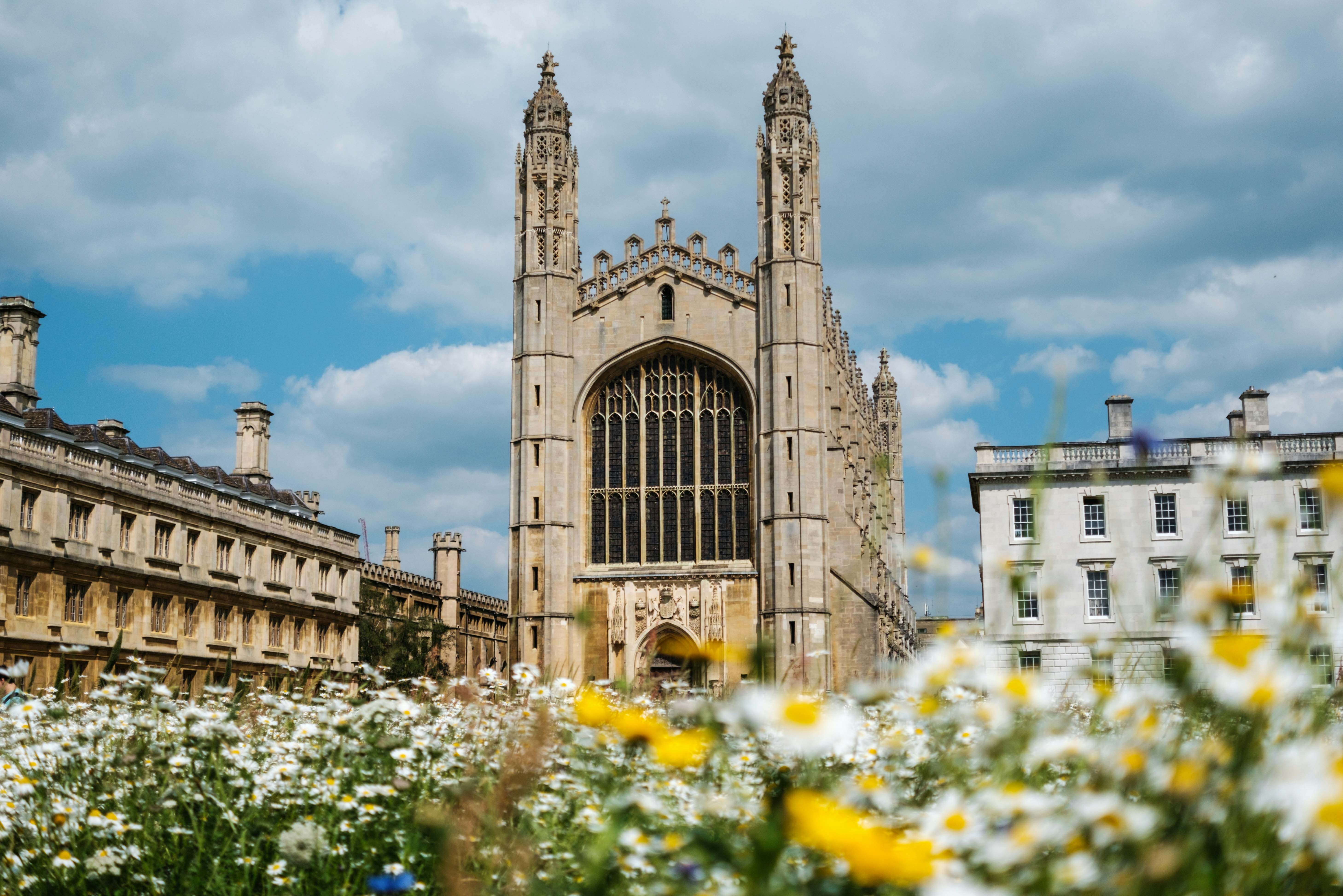 A view of Cambridge University with flowers in the foreground