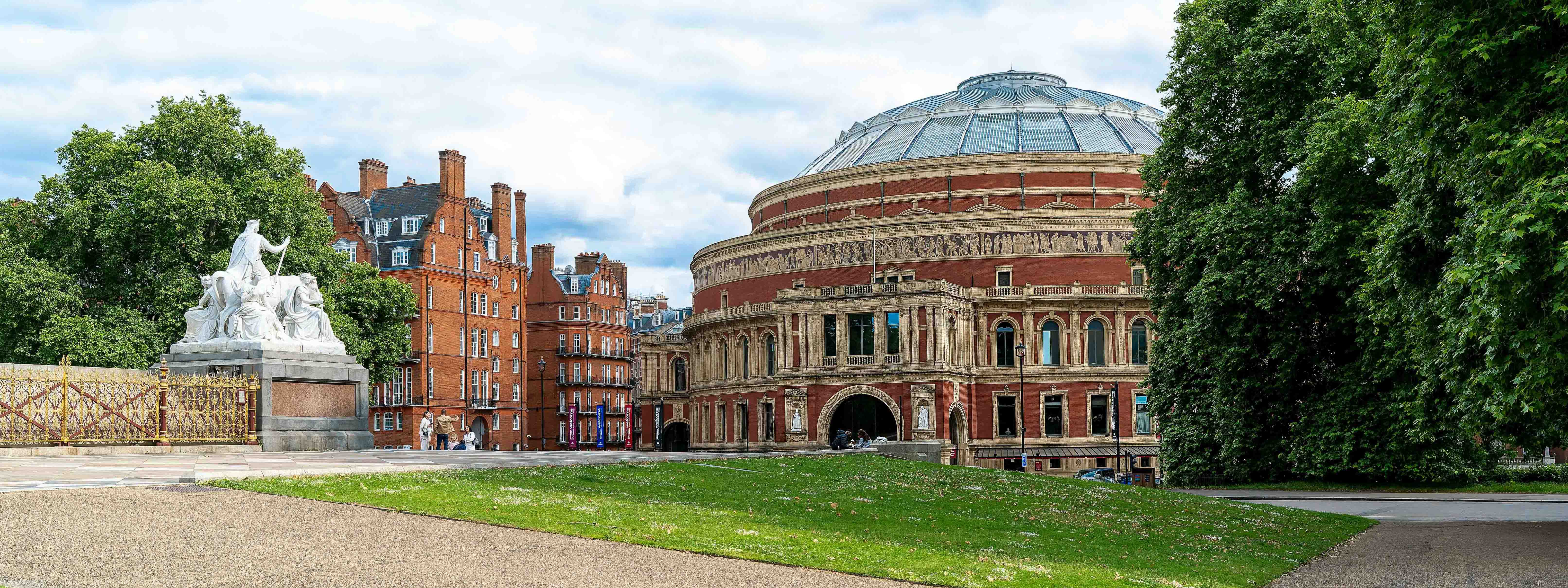 Royal Albert Hall in London with green lawn in front. 