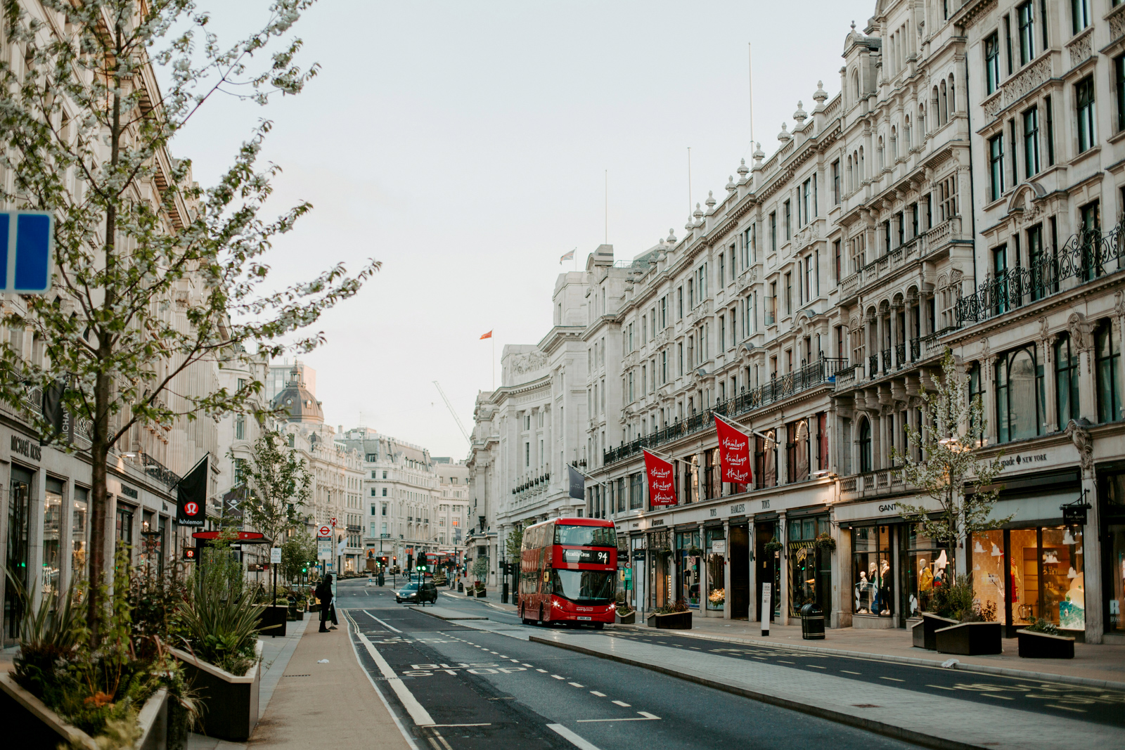 A view of a city street in London with a red double decker bus.