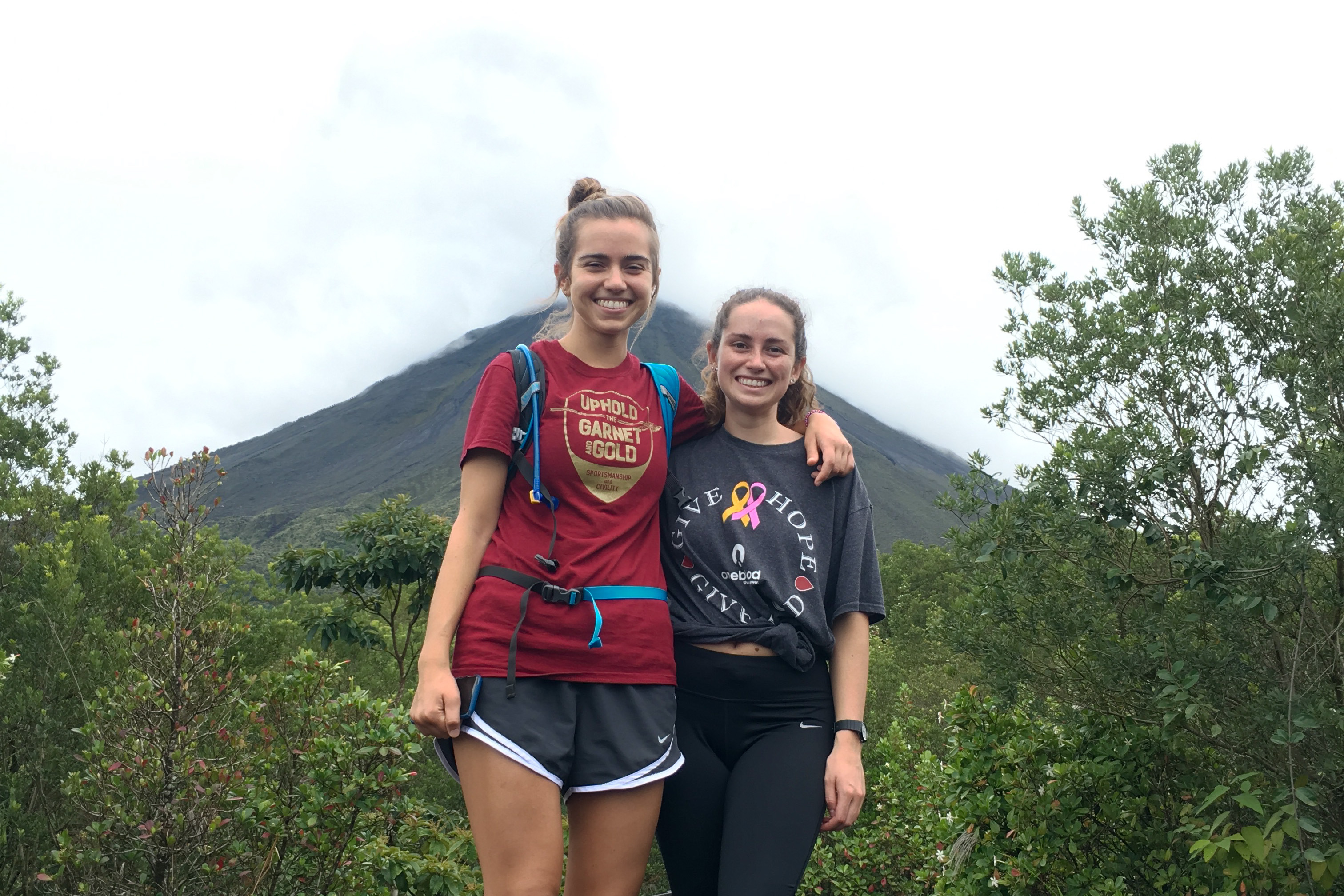 Students posing on a hike in front of a volcano in Costa Rica.