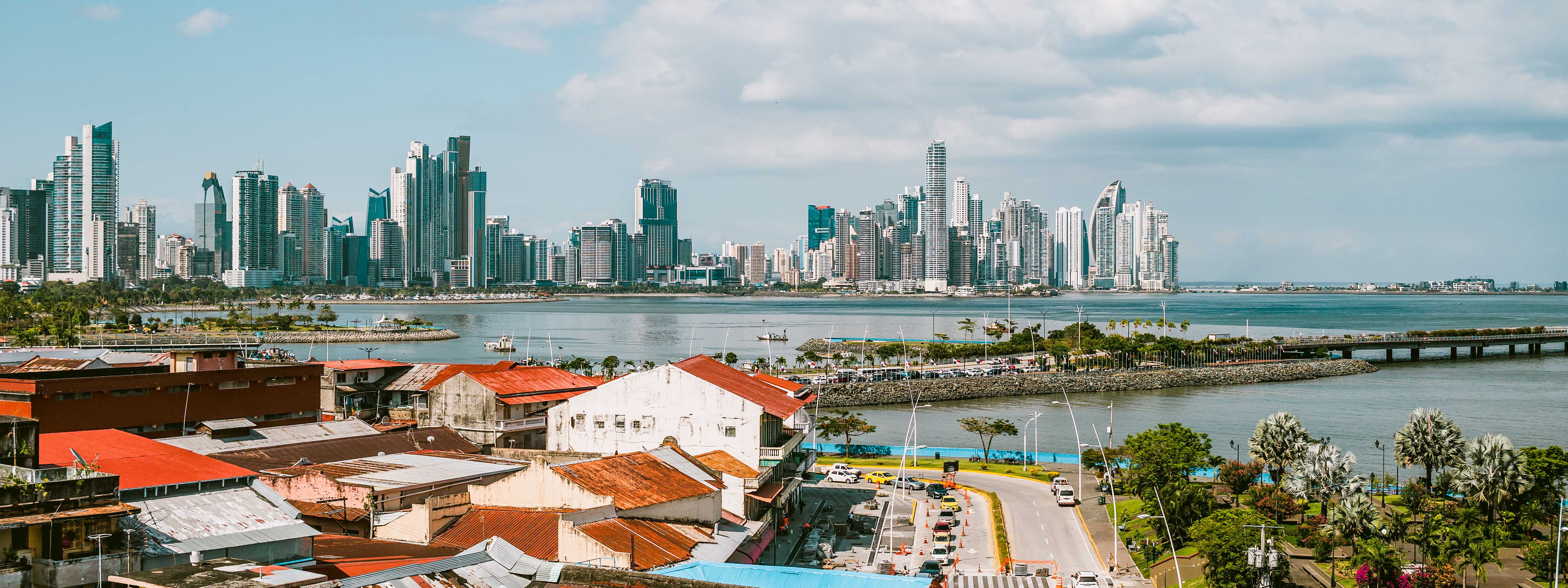 Panama City's old town in the foreground with the modern downtown area across the water in the distance.