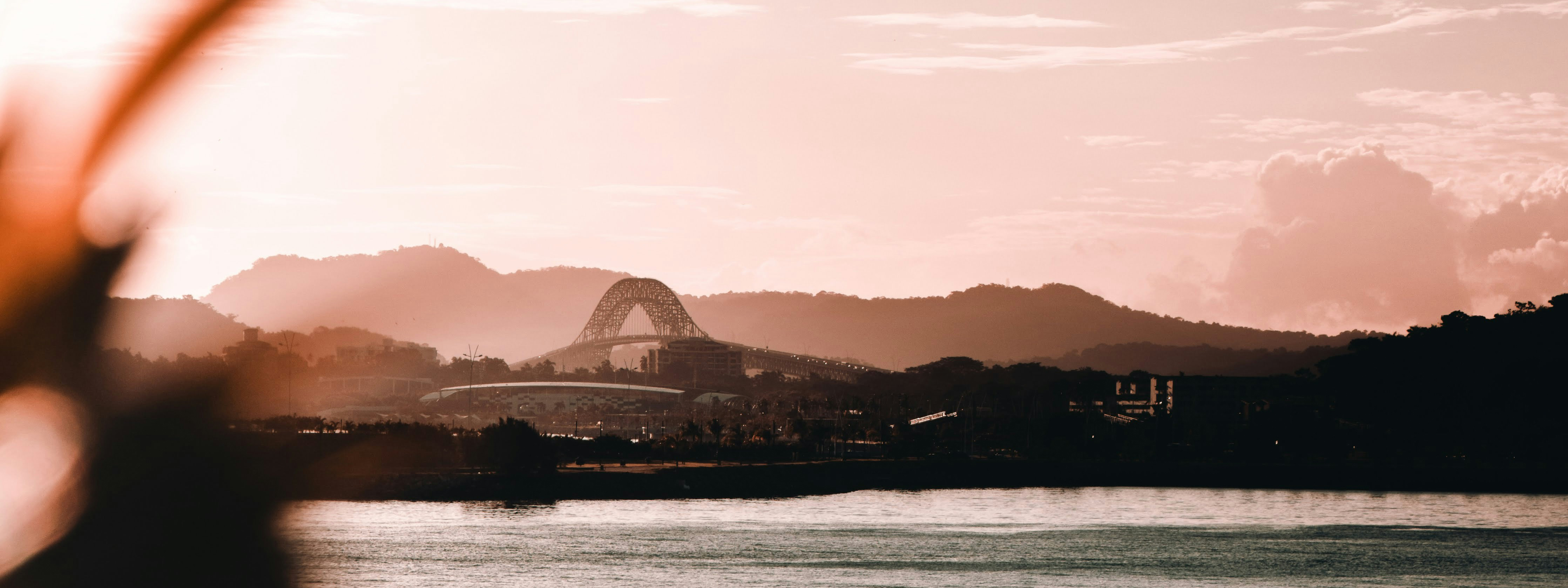 A view of the Bridge of the Americas in Panama at sunset.