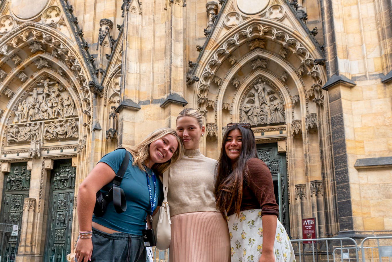 Students pose in front of a church facade in Prague.