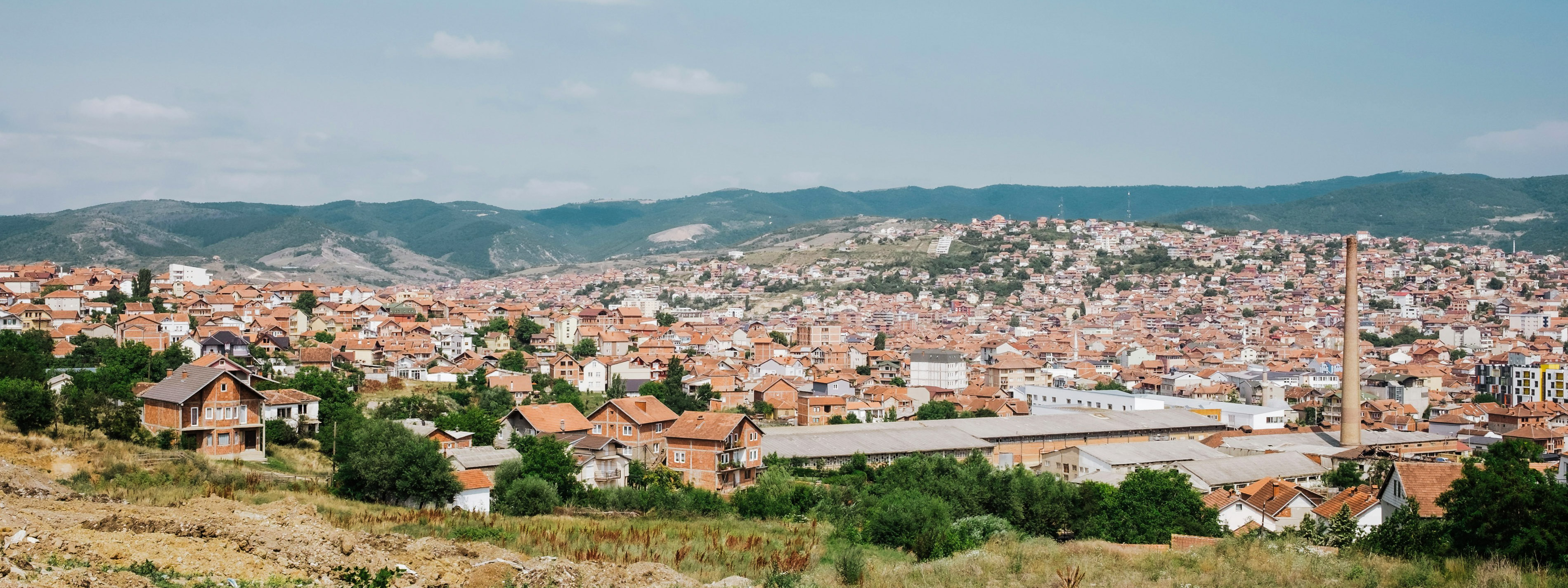 A view of houses from up on a hill in Pristina.