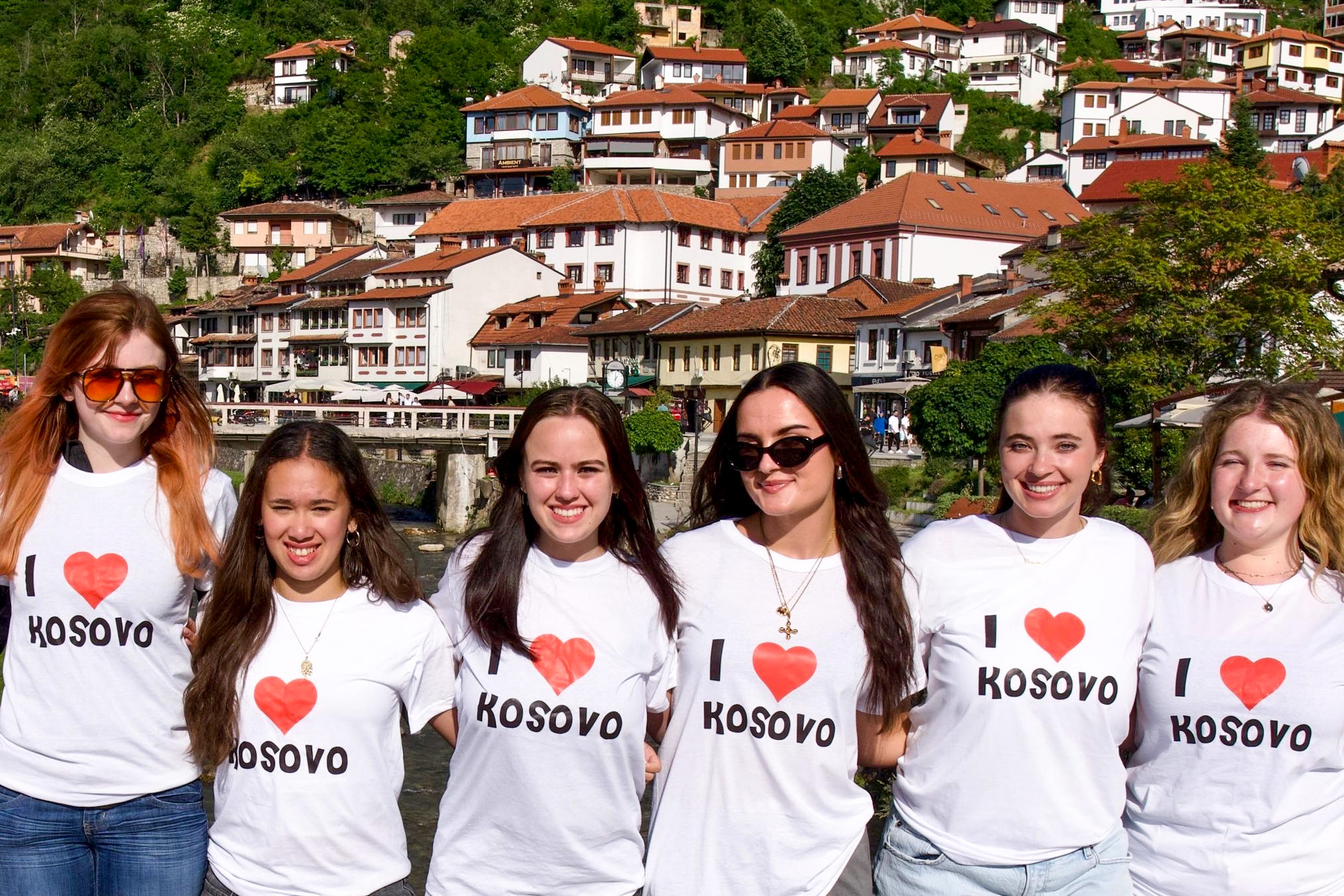 Students posing together in I heart Kosovo shirts
