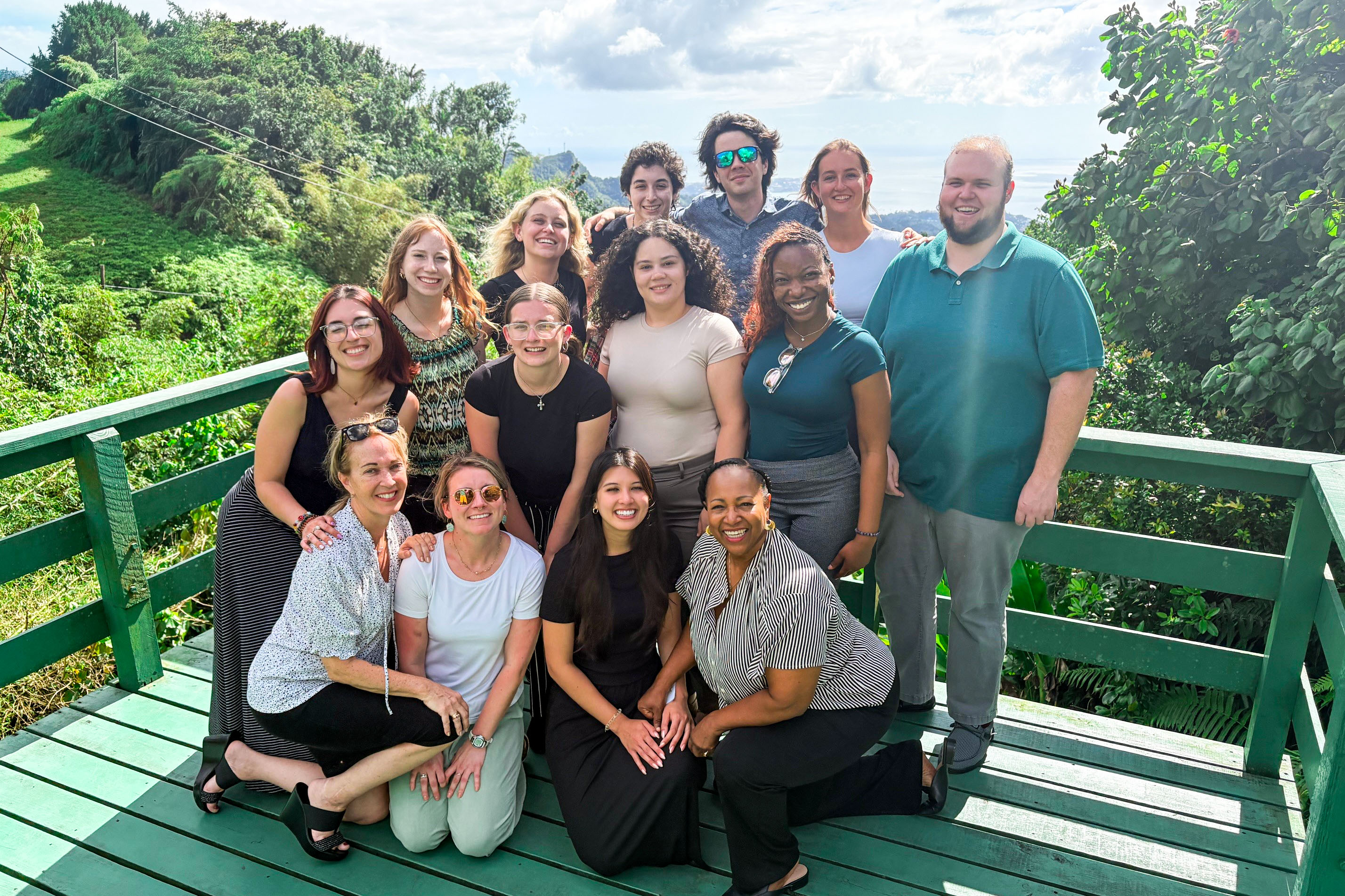 Students pose together with the beautiful tropical nature of Grenada behind them.