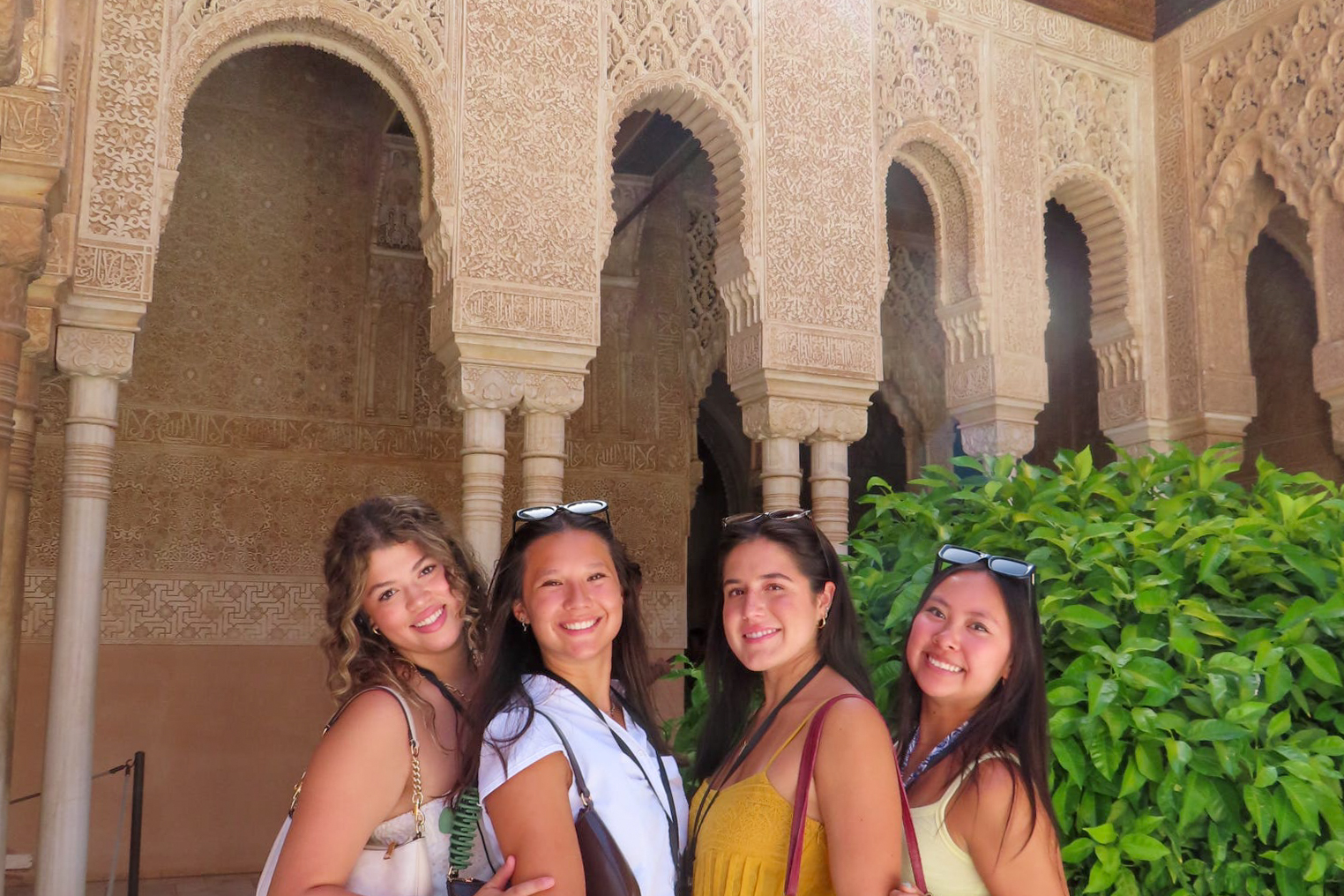Students posing together in front of a historic building.