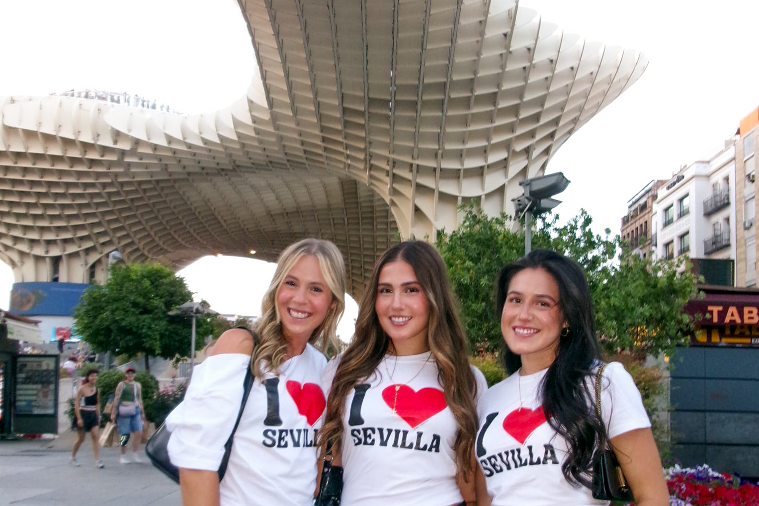 Students posing in Seville with I heart Sevilla shirts.