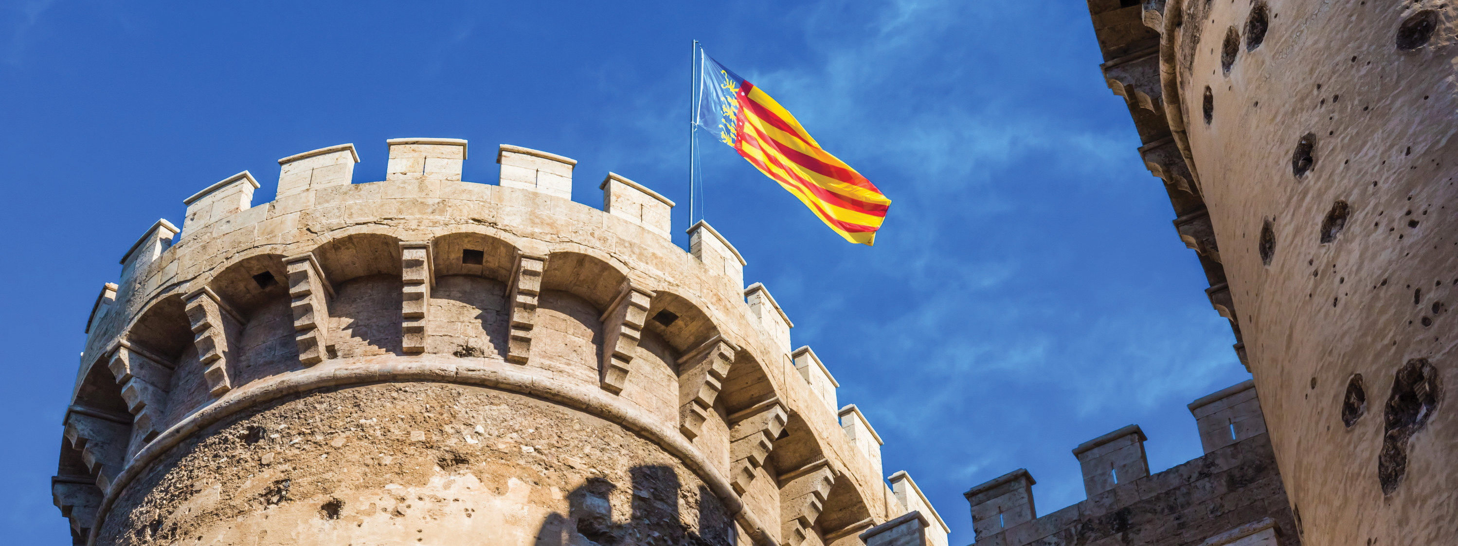 A view of a Valencian flag atop the Serrano Towers in Valencia.