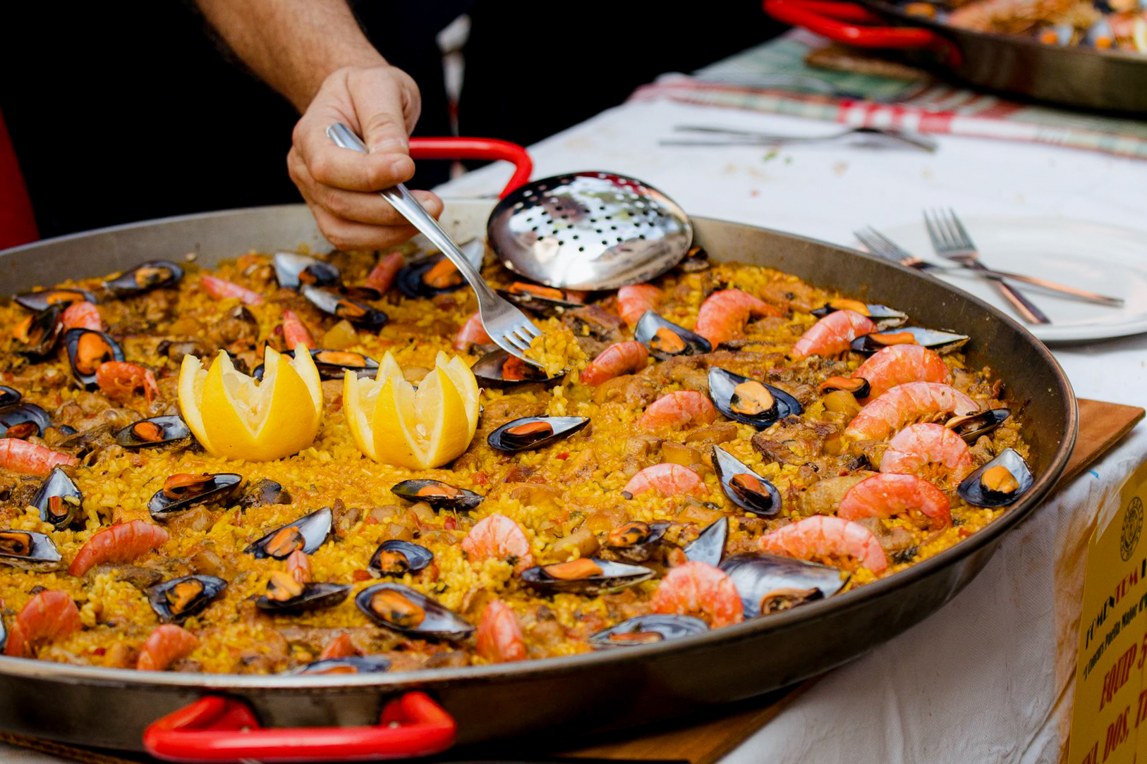 A view of someone cooking paella.