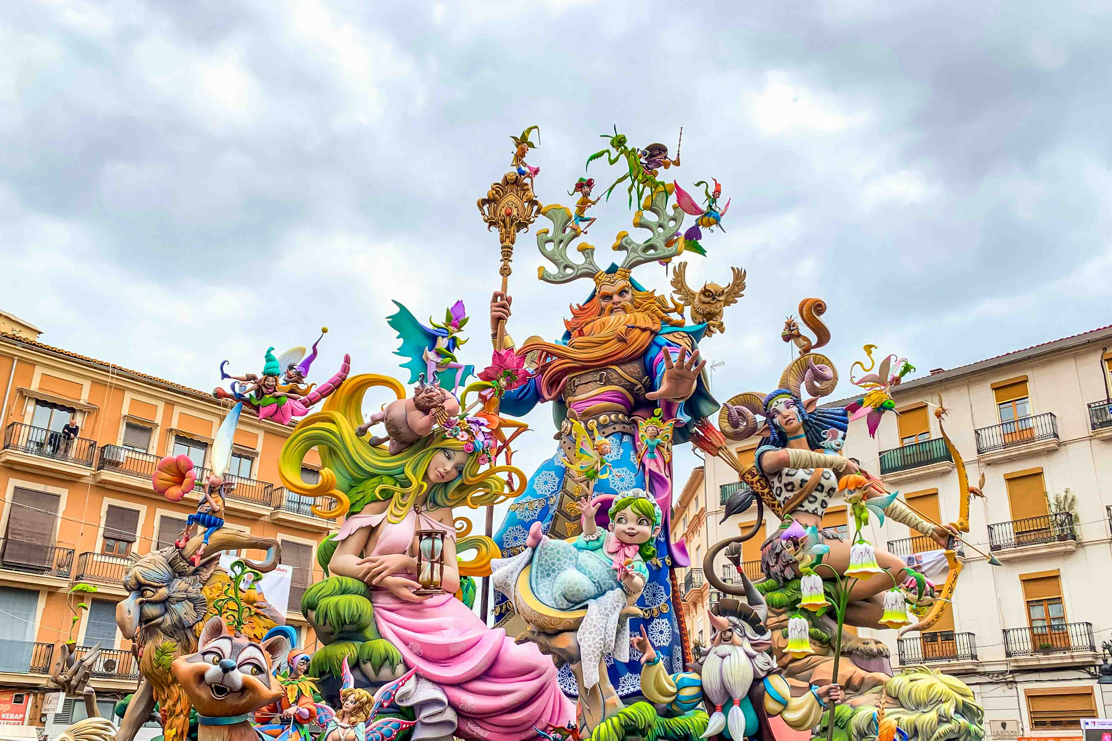 A falla, an artistic sculpture the size of a building, has colorful features.