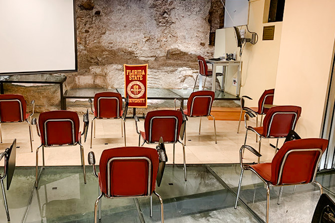 An FSU Valencia classroom with glass floors showing 14th century leather tanning tanks and archaeological remains of old river docks.