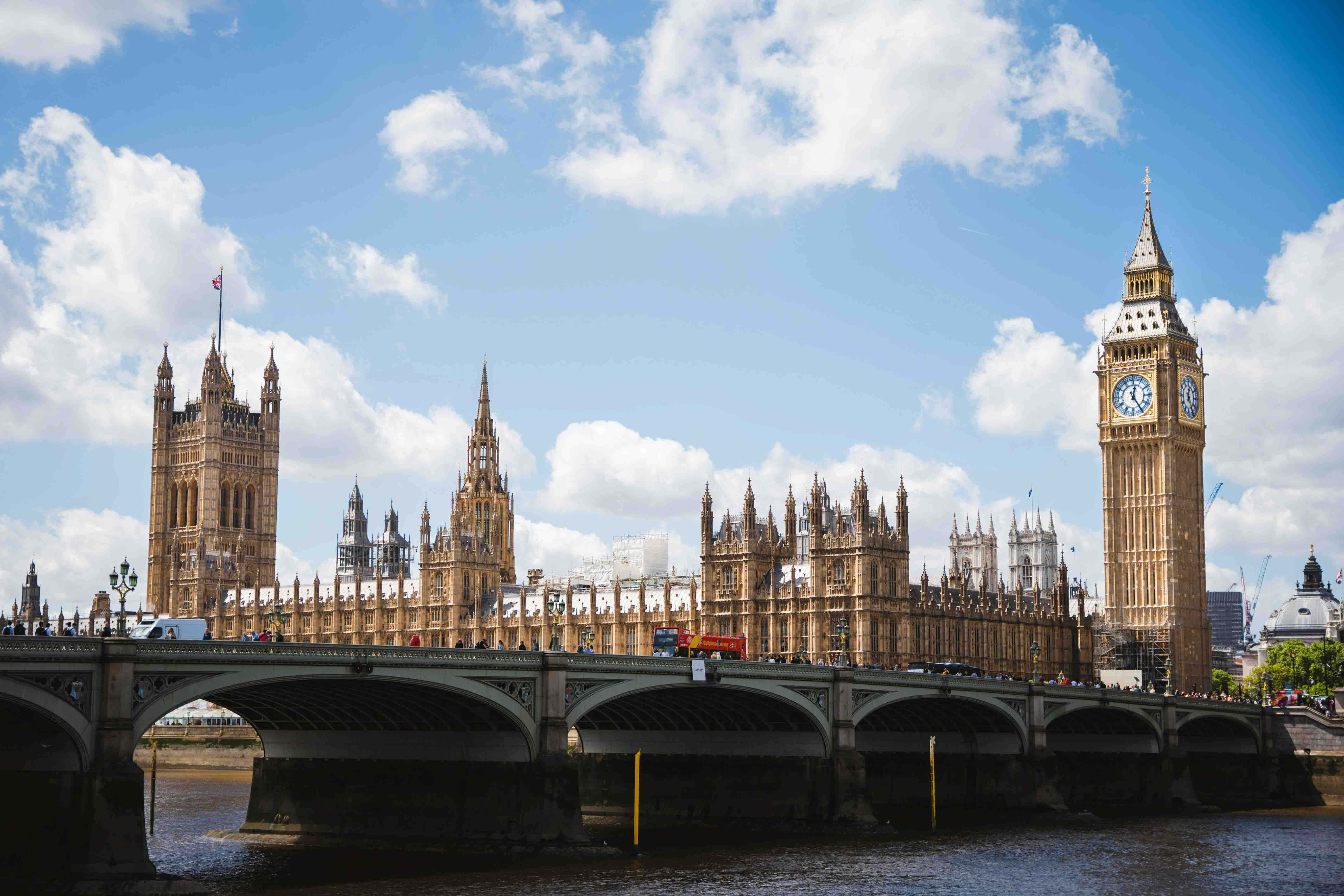 Big Ben and the Houses of Parliament as seen from across the River Thames on a sunny day.