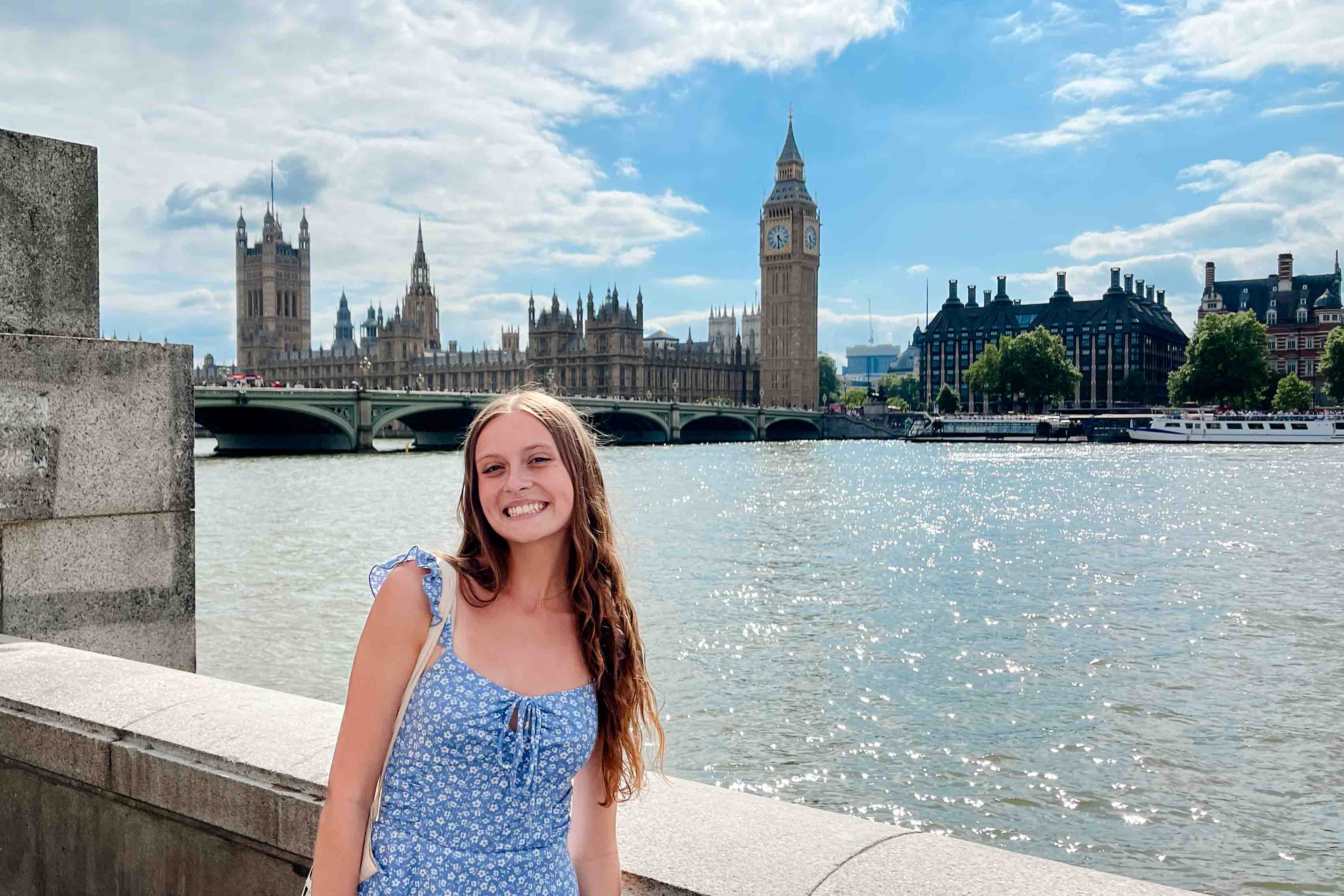 A student stands across the river Thames from Big Ben in London.
