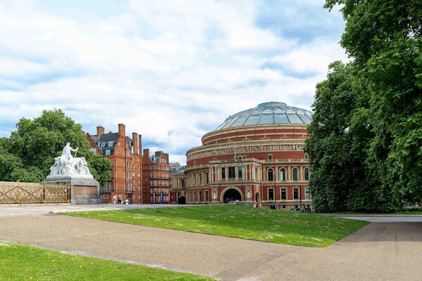 Royal Albert Hall in London with lawn and walkways in the foreground.
