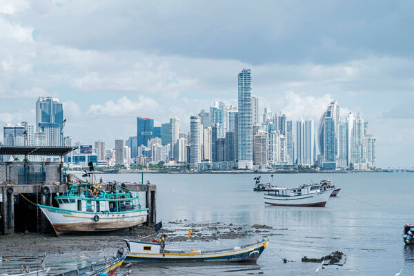 A view of Panama City with boats in the harbor in the foreground. 