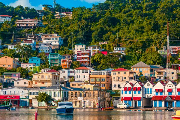A view of the harbor in Grenada with colorful buildings.