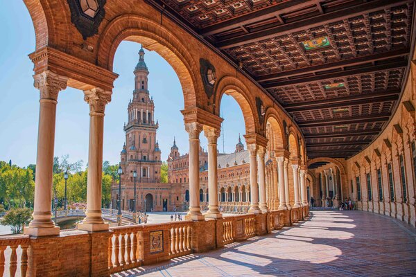 A view of historic buildings and archways in Seville.